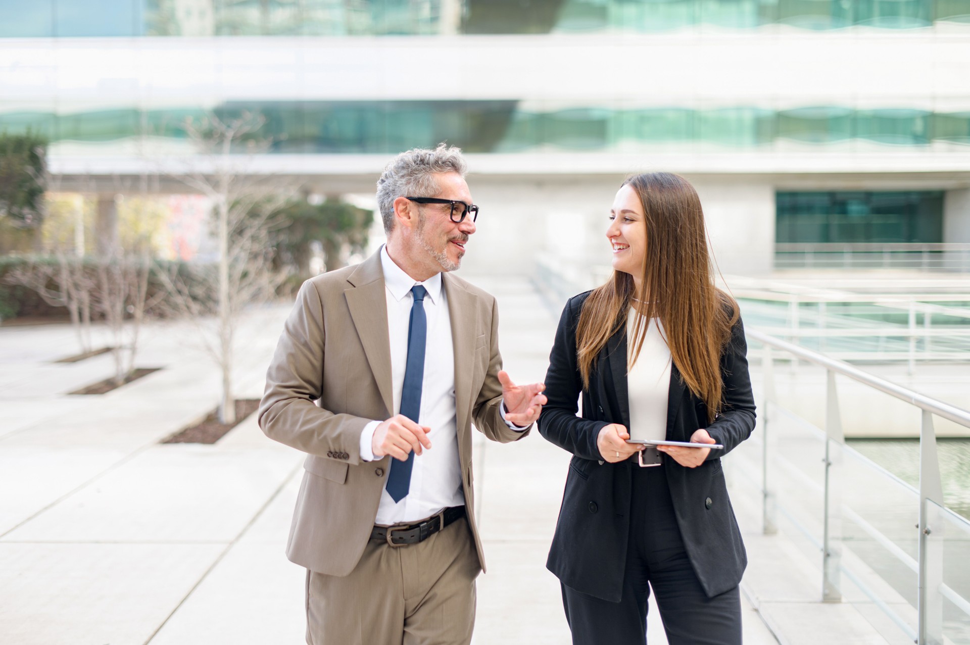 The mature businessman engages in an animated discussion with his female associate